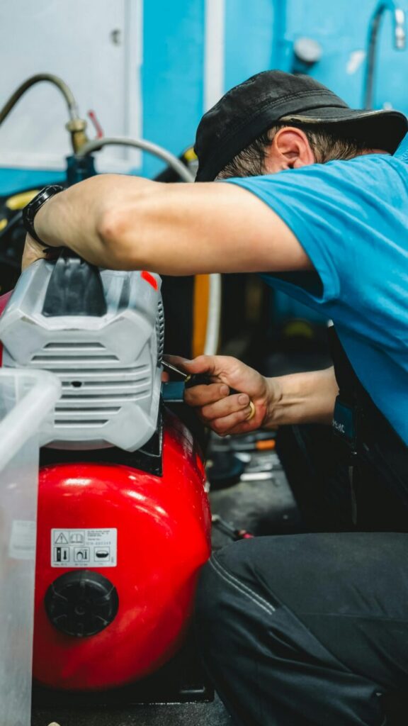 Technician servicing industrial equipment during maintenance work
